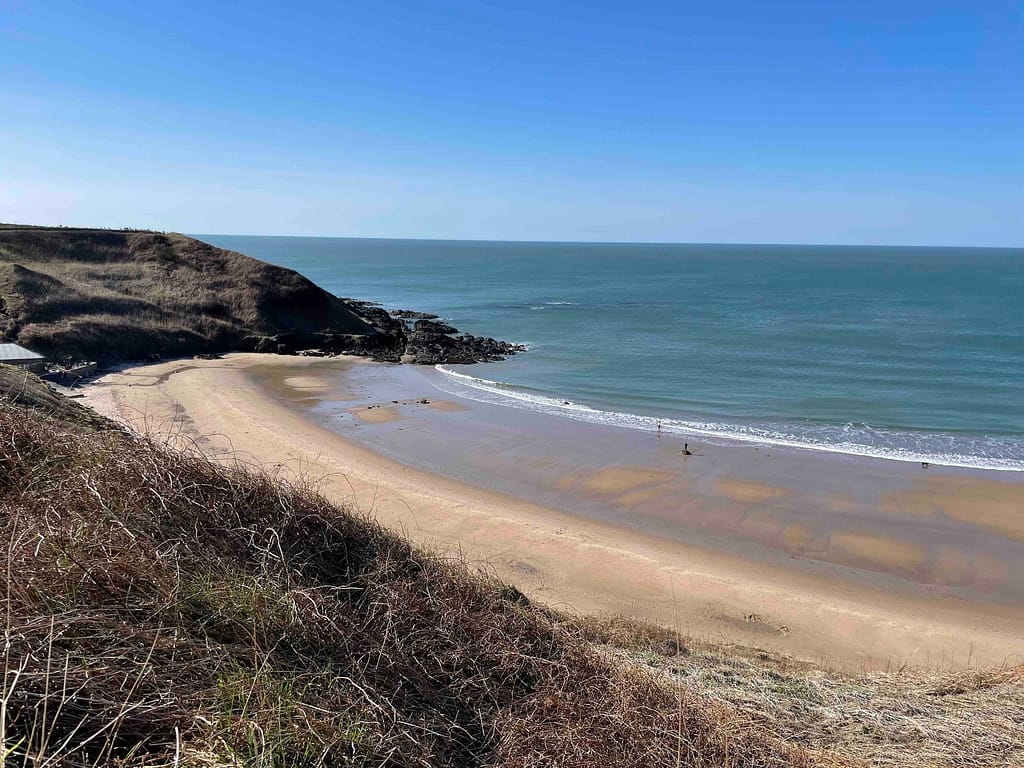 Soft sandy beach at the Whistling Sands where you can hear the sand whistles as you shuffle your feet