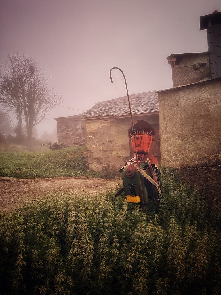 Foggy morning in Grandas de Salime, a sculpture made from recycled farming machineries